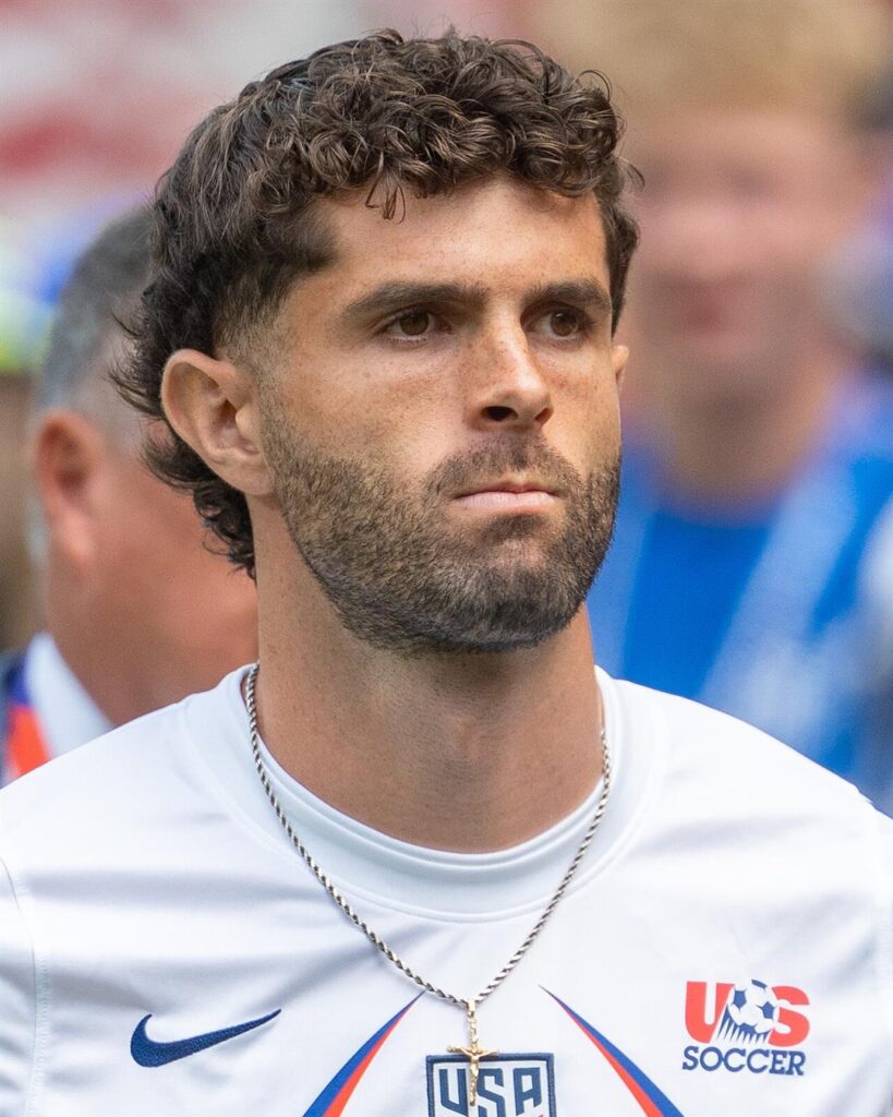 Christian Pulisic in a white USA warm-up shirt before a World Cup game in June 2026