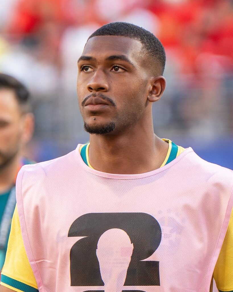 Rayan in a pink training bib over the Brazil shirt before a World Cup game