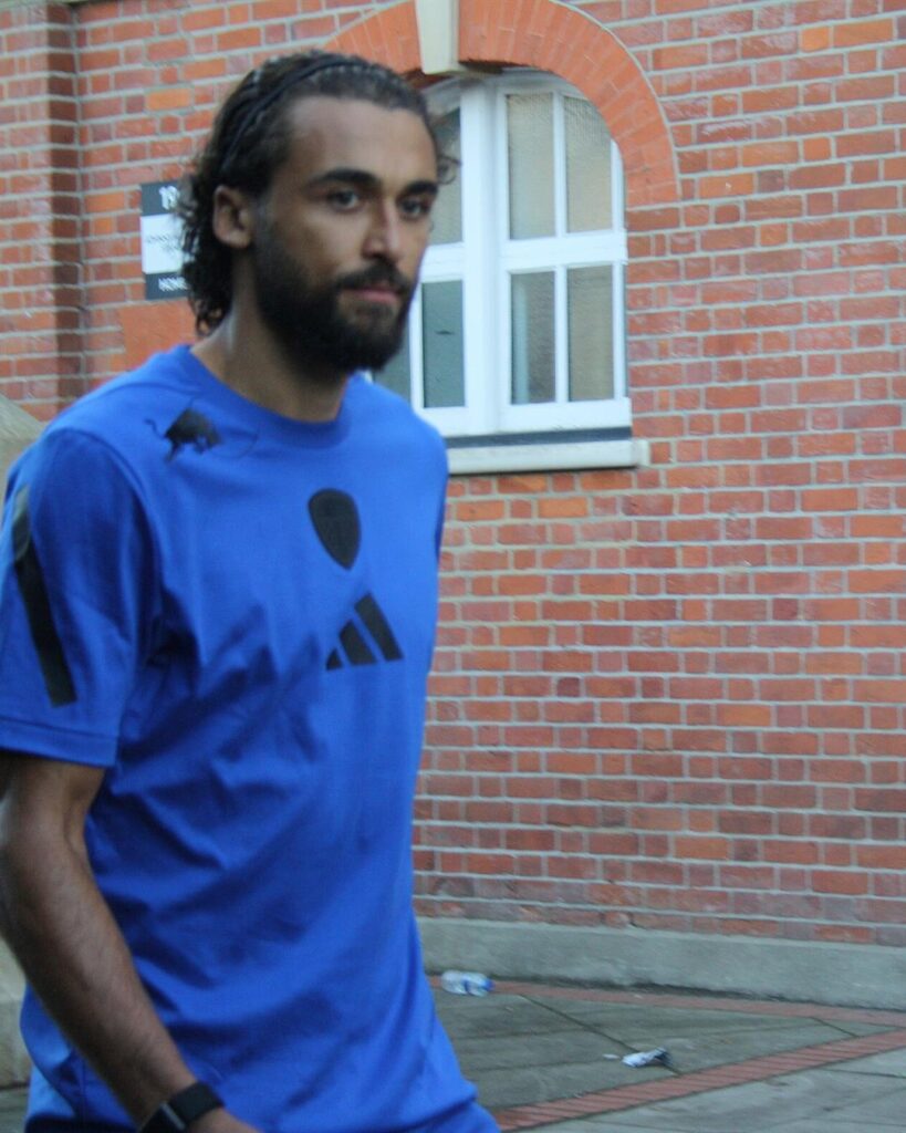 Dominic Calvert-Lewin in a blue Leeds training shirt outside a stadium