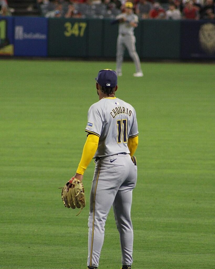 Jackson Chourio, number 11, standing in the outfield with his glove