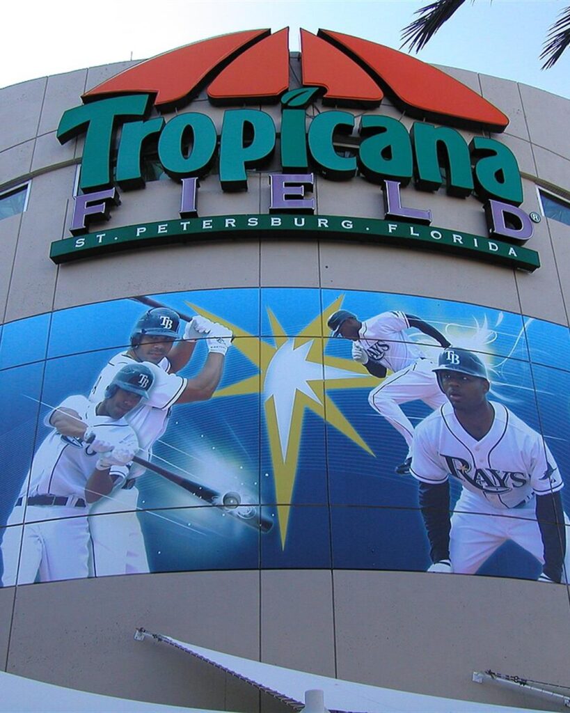 The Tropicana Field entrance sign with a Rays mural