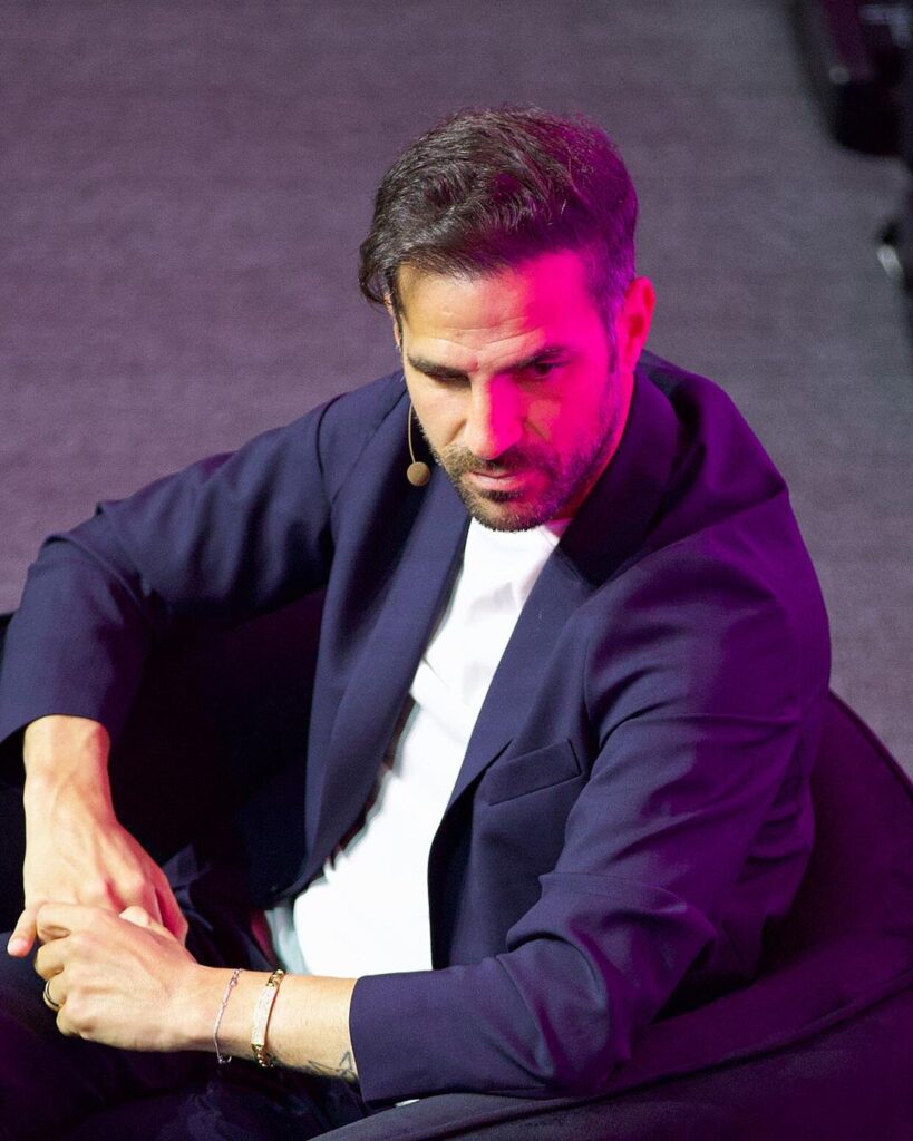 Cesc Fabregas sitting on stage at SXSW London 2025 in a navy jacket and white shirt