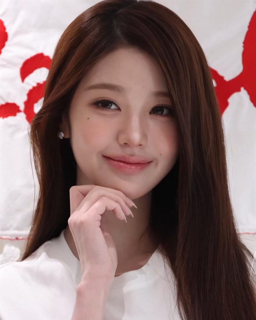 Jang Won-young of IVE smiling at a photo call in a white top