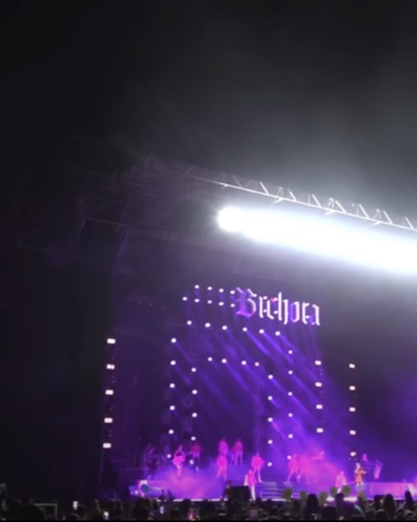 The Bichota Tour stage in El Salvador with the Bichota sign lit in purple