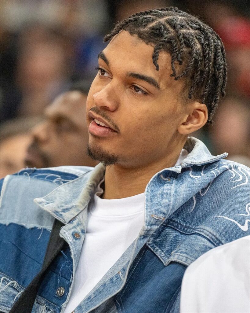 Victor Wembanyama in a denim jacket watching courtside at the NBA Paris Game